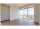 Bedroom features hardwood floors, double closet doors, and large windows with city views at 110 N Corcoran St # 2101, Durham, NC 27701