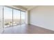 Bright bedroom with hardwood floors and large windows offering panoramic city views at 110 N Corcoran St # 2101, Durham, NC 27701