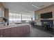 Clubhouse with large windows, modern kitchen, and seating area for residents at 110 N Corcoran St # 2101, Durham, NC 27701