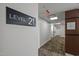 Hallway on Level 21 featuring carpet flooring, leading to white doors, and a fire evacuation plan at 110 N Corcoran St # 2101, Durham, NC 27701