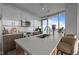 Modern kitchen features stainless steel appliances, white cabinets and counter seating at 110 N Corcoran St # 2101, Durham, NC 27701