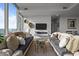 Open concept living room featuring a modern fireplace, neutral tones, and floor-to-ceiling windows at 110 N Corcoran St # 2101, Durham, NC 27701