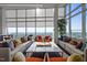 Relax in the sun filled resident lounge with comfortable seating, fireplace, and city views at 110 N Corcoran St # 2101, Durham, NC 27701