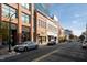 A street view of commercial buildings with pedestrian access, reflecting a vibrant urban environment at 110 N Corcoran St # 2101, Durham, NC 27701