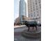 A street view featuring modern buildings surrounding a bull sculpture, highlighting the property's cultural setting at 110 N Corcoran St # 2101, Durham, NC 27701