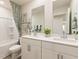 Bright bathroom with double sinks, framed mirrors, and a shower-tub combination at 1120 Landen Creek Ln, Zebulon, NC 27597