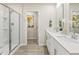 Modern bathroom featuring a double vanity, a glass-enclosed shower, and sleek fixtures at 1120 Landen Creek Ln, Zebulon, NC 27597