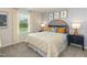Cheery bedroom featuring a rattan headboard, blue nightstands, and floral curtains at 1120 Landen Creek Ln, Zebulon, NC 27597