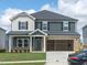 Two-story home featuring a two-car garage, a covered front porch, and a well-manicured lawn at 1120 Landen Creek Ln, Zebulon, NC 27597