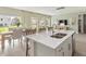 Open-concept kitchen island with a double sink offering views into the connected living and dining areas at 1120 Landen Creek Ln, Zebulon, NC 27597