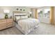 Comfortable main bedroom features natural light from large window, side tables, and stylish lamps at 1120 Landen Creek Ln, Zebulon, NC 27597