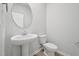 Bathroom featuring a pedestal sink and toilet at 1121 Landen Creek Ln, Zebulon, NC 27597
