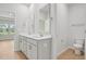Bright bathroom boasts a double vanity with modern fixtures and a view to the next room at 1121 Landen Creek Ln, Zebulon, NC 27597