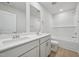 Clean bathroom with a double vanity, white cabinets, and a tub shower combo at 1121 Landen Creek Ln, Zebulon, NC 27597