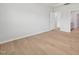 Bedroom with light wood floors and bright natural light and view to bathroom at 1121 Landen Creek Ln, Zebulon, NC 27597