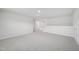 Bright bonus room with carpet, a half-wall, and access to additional rooms at 1121 Landen Creek Ln, Zebulon, NC 27597