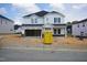 Two-story home featuring a black roof, light siding, and a welcoming front porch, still under construction in a new community at 1121 Landen Creek Ln, Zebulon, NC 27597