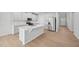 Modern kitchen with quartz countertops, a spacious island, and stainless-steel appliances at 1121 Landen Creek Ln, Zebulon, NC 27597