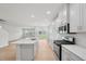 Bright, open kitchen featuring white cabinets, an island with a sink, and stainless steel appliances at 1121 Landen Creek Ln, Zebulon, NC 27597