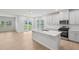 Spacious kitchen featuring modern stainless appliances, island, and view to backyard at 1121 Landen Creek Ln, Zebulon, NC 27597