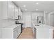 Beautiful, modern kitchen with stainless steel appliances, a large island, and ample cabinet space at 1121 Landen Creek Ln, Zebulon, NC 27597