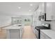 Open-concept kitchen with modern appliances, a large island, and seamless flow to the backyard at 1121 Landen Creek Ln, Zebulon, NC 27597