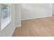 Bright living room featuring light wood floors, white walls, and ample natural light from the windows at 1121 Landen Creek Ln, Zebulon, NC 27597