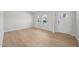 Bright living room featuring light wood floors, white walls, and ample natural light from the windows at 1121 Landen Creek Ln, Zebulon, NC 27597