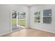 Bright living room with sliding glass doors to backyard and double windows at 1121 Landen Creek Ln, Zebulon, NC 27597