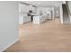 Open-concept living room with staircase and adjacent kitchen at 1121 Landen Creek Ln, Zebulon, NC 27597