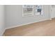 Bright living room featuring light wood floors, white walls, and ample natural light from the windows at 1121 Landen Creek Ln, Zebulon, NC 27597
