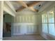 Light-filled dining area with a tray ceiling, large windows, and custom built-in cabinets at 11226 Old Beulah Rd, Kenly, NC 27542