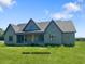 Under construction home featuring a traditional exterior, well-manicured lawn and clear blue skies at 11226 Old Beulah Rd, Kenly, NC 27542