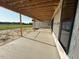 Long porch spanning the length of the back of the home with an extended concrete patio at 11226 Old Beulah Rd, Kenly, NC 27542