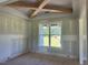 New living room showcasing exposed beams and a large window with picturesque views at 11226 Old Beulah Rd, Kenly, NC 27542