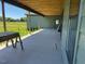 Covered patio featuring wooden beams and a peaceful view of the surrounding green landscape at 11226 Old Beulah Rd, Kenly, NC 27542