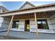 View of the unfinished porch with exposed support beams and black framed windows at 11226 Old Beulah Rd, Kenly, NC 27542