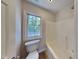 Functional bathroom featuring a toilet, tub with shower, and a window providing natural light at 113 Union Mills Way, Cary, NC 27519