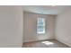 A bright bedroom featuring a window and neutral carpet at 113 Union Mills Way, Cary, NC 27519