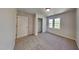 Bright bedroom with neutral carpet, large windows, and closet space, creating a comfortable and versatile area at 113 Union Mills Way, Cary, NC 27519