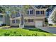 Charming two-story home with a well-manicured lawn and inviting curb appeal, featuring red shutters and a one car garage at 113 Union Mills Way, Cary, NC 27519