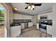 Well-lit kitchen with stainless steel appliances, white cabinets, mosaic tile backsplash, and sliding door leading to deck at 113 Union Mills Way, Cary, NC 27519
