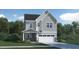Charming two-story home boasts a welcoming entrance, complemented by a two-car garage, lush lawn and manicured landscaping at 1209 Coral Cay Bnd, Wake Forest, NC 27587