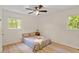This bedroom offers wood flooring, bright natural light, and ceiling fan at 1209 Shincliffe Ct, Cary, NC 27511