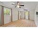 This bedroom offers wood flooring, bright natural light, and ceiling fans at 1209 Shincliffe Ct, Cary, NC 27511