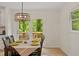 Dining area with table and chairs, light fixture, and view of the deck through glass doors at 1209 Shincliffe Ct, Cary, NC 27511