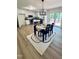 Well-lit dining area featuring hardwood floors and modern lighting fixture at 1209 Shincliffe Ct, Cary, NC 27511
