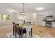 Open-concept dining area with kitchen views, and stylish lighting at 1209 Shincliffe Ct, Cary, NC 27511