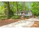 Two-story house with light siding, a well-maintained lawn, mature trees, and a paved driveway leading up to the property at 1209 Shincliffe Ct, Cary, NC 27511
