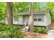 Charming split-level home with a brick foundation, light siding and a well-manicured front yard filled with mature trees at 1209 Shincliffe Ct, Cary, NC 27511